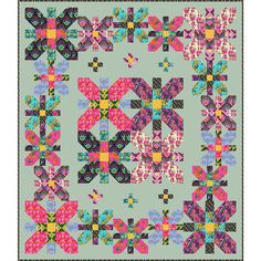 a colorful quilt with an intricate design on it's center and two rows of flowers in the middle