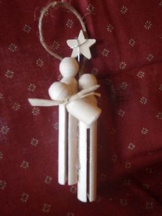 a small wooden decoration hanging from a string on a red cloth covered tablecloth with white stars