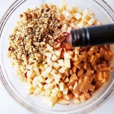 chopped apples and other ingredients in a glass bowl