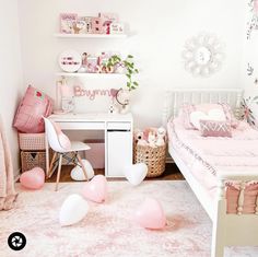 a bedroom decorated in pink and white with balloons on the floor