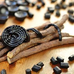 some black beads and sticks on a wooden table