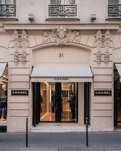 a chanel store front with mannequins on the windows