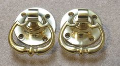 two brass door handles on carpeted floor