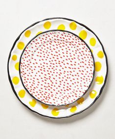 a white plate with yellow and red dots on it