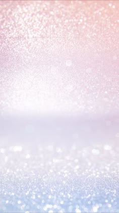 a blurry background with white and pink sparkles on the bottom right corner, as well as light blue in the middle