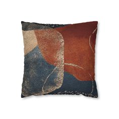 an orange, blue and brown pillow on a white background