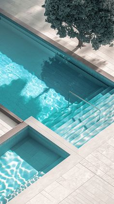 an aerial view of a swimming pool with steps leading up to it