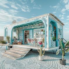 a small blue and white house on the beach