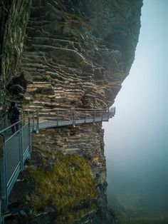 a person standing on the edge of a cliff