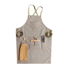 an apron with scissors and other items hanging from it's back pocket on a white background