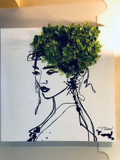 a drawing of a woman's face with green leaves on her head is shown