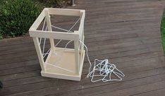 a wooden box sitting on top of a wooden deck next to a pile of wires