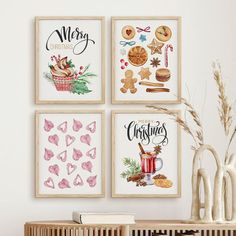 three framed christmas cards on a wall next to a vase with flowers and other decorations