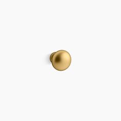 a gold door knob on a white wall