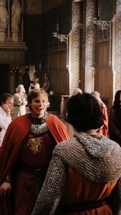 two women dressed in medieval costumes talking to each other