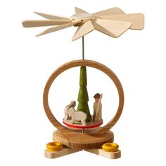 a wooden wind spinner with two figurines in it