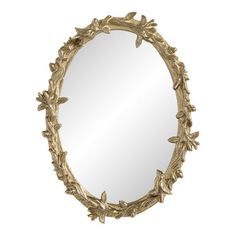 an oval mirror with leaves on the edge and a gold frame, against a white background