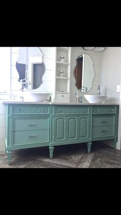 a bathroom with two sinks and a large mirror