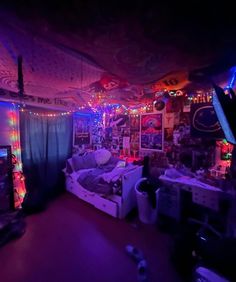 a bedroom with purple lights and pictures on the walls