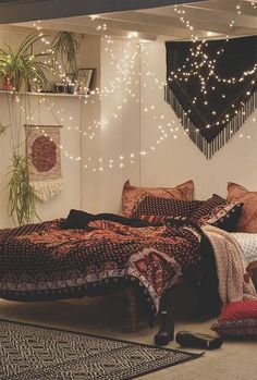 a bed room with a neatly made bed and lots of string lights hanging from the ceiling