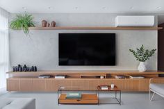 a large flat screen tv mounted to the side of a wall in a living room