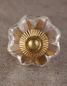 a gold and clear flower shaped object on the ground