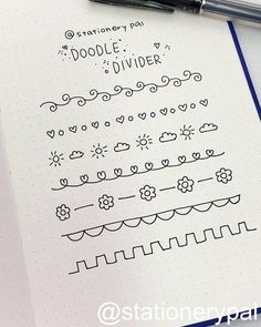 the doodle divider is on top of a notebook next to a pen and paper