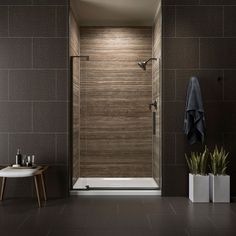 a bathroom with a walk in shower sitting next to a sink and a bathtub