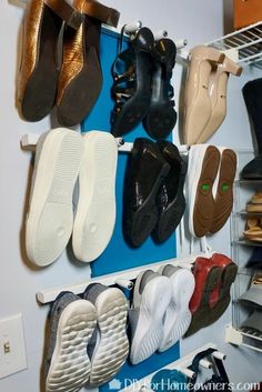 there are many pairs of shoes hanging on the wall