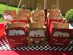 some paper bags that have cars on them