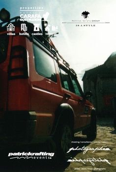 a red van parked on top of a dirt road