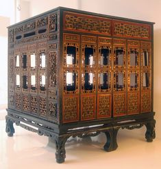 an ornate wooden cabinet sitting on top of a white floor