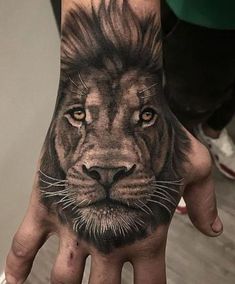 a hand with a lion tattoo on it