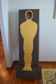 a cardboard cut out of an oscar statue