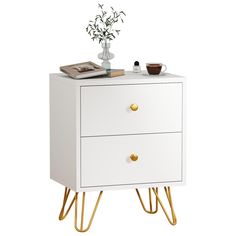 a white cabinet with two gold legs and a potted plant on top