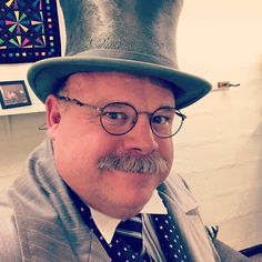 a man wearing a top hat and glasses