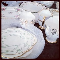 a table topped with lots of white dishes