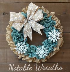 a wreath with snowflakes is hanging on a wooden wall that says, notake wreaths