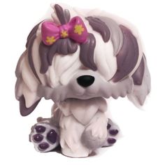 a white and gray dog with a pink bow on it's head sitting down