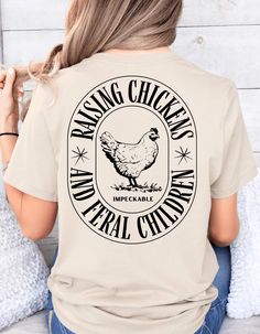 Bring a touch of Western charm to your wardrobe with our raising chickens and feral print t-shirt. Made with quality materials, this stylish shirt is perfect for chicken raising mom!  Show off your love for the Western lifestyle with this must-have apparel piece. *SIZE AND MATERIAL This is a women's relaxed fit Tee, 100% cotton. It's made of durable, soft 100% cotton, so you can wear it in comfort and confidence. It's designed to stand up to regular wear and tear while staying soft to the touch. Show Mom Shirts Livestock, Crazy Chicken Lady Shirt, Chicken Raising, Farm Tees, Crazy Chicken, Chicken Shirt, Farm Store, Crazy Chicken Lady, Western Lifestyle