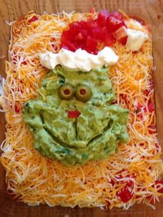 an image of a face made out of cheese and guacamole