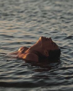 a woman floating on top of a body of water