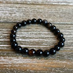 "Introducting the \"Blaze\" Collection! Beautiful individually or complete the look with a stack that makes a statement. vMix and match to find the look you love. Look stylish with an 8mm Natural Black Larvikite, 8mm Red Agate, 8mm Black Agate, and/or 8mm Smoky Quartz bead bracelet! Available accented with or without spacer beads and charms. (Please specify in the personalization section). Water proof and sturdy, yet shiny and chic! Held together with heavy duty stretchy bead cord. SIZING: Every Black Beaded Bracelets With Spacer Beads As Gift, Black Beaded Bracelet Gift, Black Crystal Bracelet With Spacer Beads For Gift, Gift Black Crystal Bracelet With Spacer Beads, Black Beaded Bracelets With Polished Beads As A Gift, Black Stretch Bracelet With Spacer Beads As Gift, Black Healing Beaded Bracelets With Round Beads, Black Beads Stretch Bracelet For Jewelry Making, Black Charm Bracelet With 8mm Beads