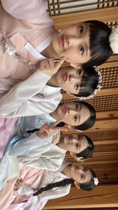 three girls in dresses standing next to each other and posing for the camera with their hands on their chins