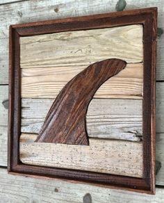 a piece of wood that has been carved into the shape of a whale