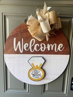 a welcome sign hanging on the front door