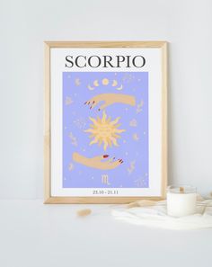 the scorpio zodiac sign is displayed in front of a candle and some other items