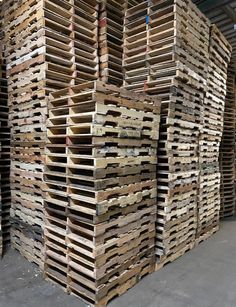 several stacks of wooden pallets stacked on top of each other