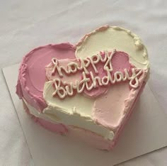 a heart shaped birthday cake with the words happy birthday written on it's side