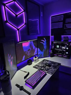 a computer desk with two monitors, keyboard and mouse in front of purple lighting on the wall